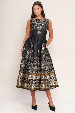 Black and gold baroque print evening look styled for a luxury event