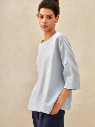 Ice blue linen boatneck top with 3/4 length sleeves by LINTICO, made from 100% breathable linen fabric.
