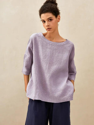Lavender 100% linen boatneck top with 3/4 length sleeves by LINTICO, showcasing a relaxed and breathable blouse style.