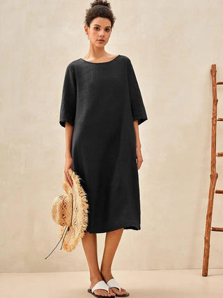 Charcoal black 100% linen collarless mid-length dress by LINTICO, featuring a relaxed fit and minimalist design.