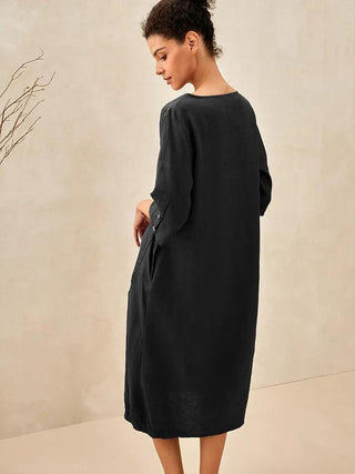 Charcoal black 100% linen collarless mid-length dress by LINTICO, shown on a hanger with a relaxed, minimalist style.