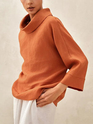 Sun orange linen long-sleeve top with dropped collar from LINTICO, showcasing its relaxed fit and lightweight 100% linen fabric.