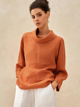 Sun orange linen long-sleeve top with a dropped collar by LINTICO, showcasing a relaxed fit and lightweight fabric.