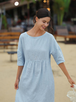 Baby blue linen A-line midi dress by LINTICO featuring a relaxed fit and elegant design, perfect for casual or semi-formal occasions.