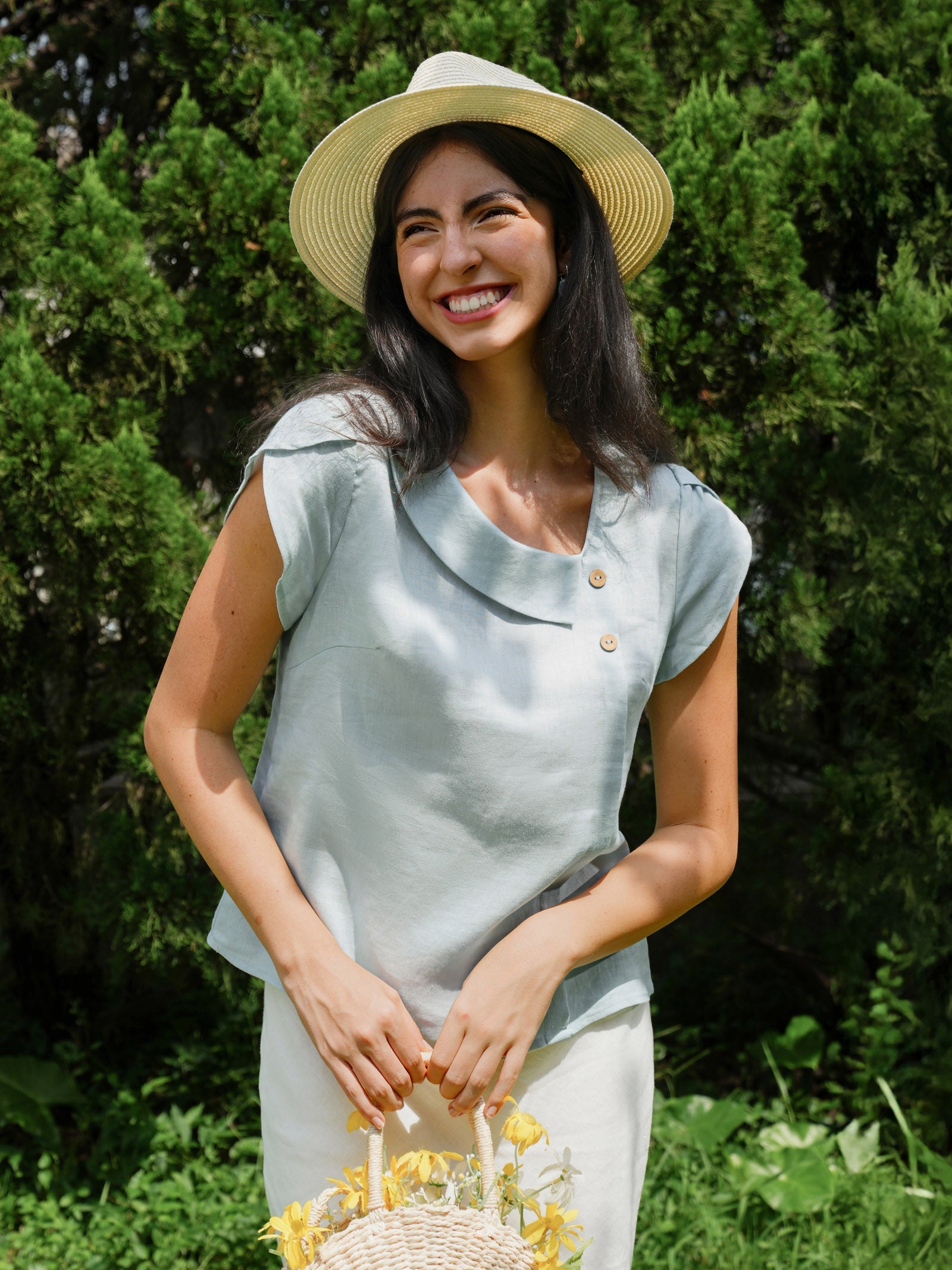Aqua blue linen blouse with crescent collar and flutter sleeves by LINTICO, showcasing lightweight, breathable fabric and stylish design.