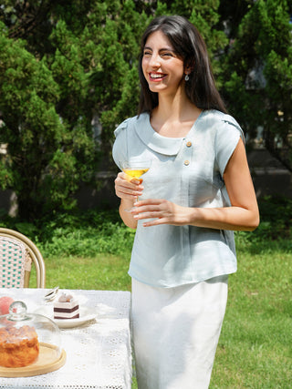 Aqua blue linen top with crescent collar and flutter sleeves by LINTICO, featuring a lightweight, relaxed fit blouse.