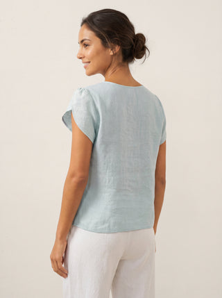 Aqua blue linen top with crescent collar and flutter sleeves by LINTICO, featuring a stylish and breathable blouse design.