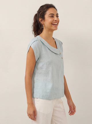 Aqua blue linen blouse with a crescent collar and flutter sleeves, designed by LINTICO.
