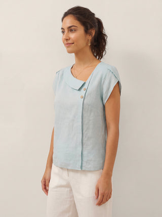 Aqua blue linen top with crescent collar and flutter sleeves by LINTICO, styled as a casual blouse with relaxed fit.