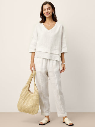 Optic white linen drop shoulder layered hem top by LINTICO, showcasing an asymmetric design and relaxed fit.