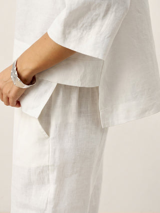 Optic white linen drop shoulder layered hem overtop shirt by LINTICO, featuring an asymmetric design and relaxed fit.