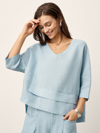 Sky blue linen drop shoulder top with asymmetric layered hem by LINTICO, casual and stylish layered linen shirt.