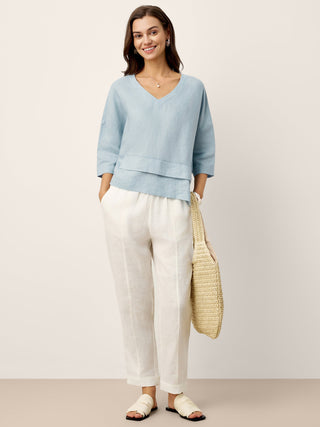Sky blue linen drop shoulder top with asymmetric layered hem by LINTICO, casual stylish overtop for a relaxed look.