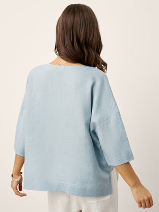 Sky blue linen drop shoulder top with asymmetric layered hem by LINTICO, casual and stylish layered shirt for everyday wear.