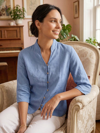 Powder blue linen fitted jacket with hand buttons from LINTICO's Amelia collection, showcasing lightweight, natural outerwear.