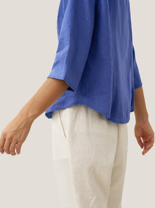 Royal blue linen fitted jacket with hand buttons, stylish outerwear by LINTICO, featuring a tailored design and button details.