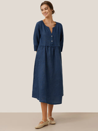 Navy blue linen maxi dress with loose fit, gathered waist, button details, and long sleeves by LINTICO.
