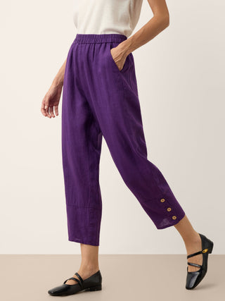 Dark purple linen tapered pants with artisan buttons from LINTICO's Katherine collection, featuring a stylish, tailored fit.