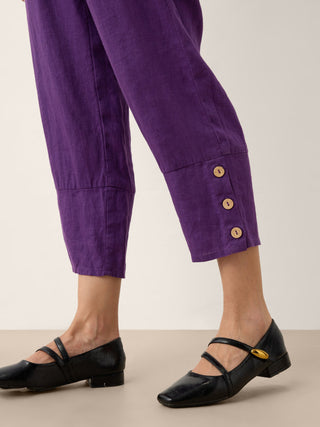 Dark purple 100% linen artisan button tapered pants by LINTICO, featuring a relaxed fit and stylish tapered silhouette.