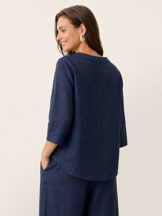 Navy blue linen top with asymmetric hem and button trim by LINTICO, showcasing a relaxed, stylish design.