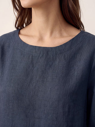 Navy blue linen top with asymmetric hem and button trim, stylish LINTICO NYLA blouse for casual or chic wear.