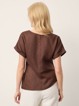 LINTICO Minerva espresso brown linen top with asymmetric hem, side gathers, and split-neck design.