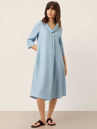LINTICO Winifred ice blue linen midi dress with asymmetric shawl collar and A-line silhouette shown on model.