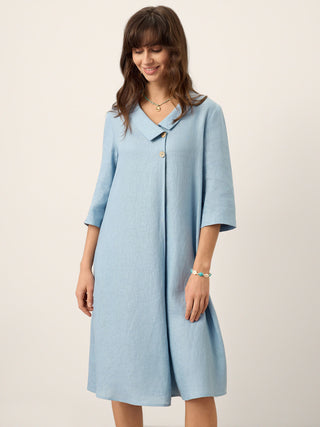 LINTICO Winifred ice blue 100% linen asymmetric shawl collar A-line midi dress displayed on a hanger.
