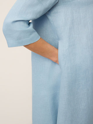 LINTICO Winifred ice blue linen midi dress with asymmetric shawl collar and A-line silhouette, perfect for casual or semi-formal wear.