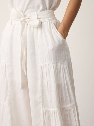 LINTICO 100% linen bow-waist tiered pants in optic white, stylish wide-leg bottoms with a relaxed fit and tiered design.