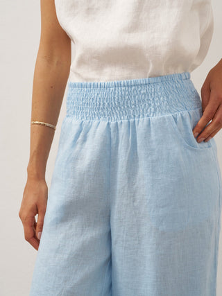 Baby blue linen pants with a broad elastic waistband by LINTICO, showcasing a relaxed fit and lightweight breathable fabric.