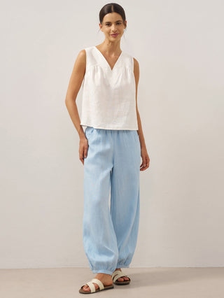 Baby blue linen pants with a broad elastic waistband by LINTICO, featuring a relaxed fit and lightweight breathable fabric.