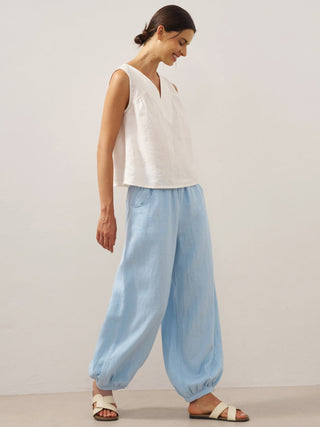 Baby blue linen pants with a broad elastic waistband from LINTICO, featuring a relaxed fit and lightweight fabric.