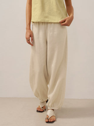 LINTICO TALIA khaki linen pants with broad elastic waistband, relaxed fit, and lightweight breathable fabric.