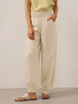 Khaki linen pants with a broad elastic waistband from LINTICO's TALIA collection, featuring a relaxed fit and comfortable design.