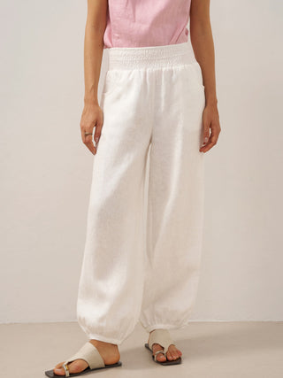 Optic white linen pants with broad elastic waistband and relaxed fit from LINTICO's Talia collection.