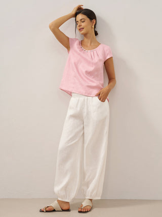 Optic white linen pants with broad elastic waistband and relaxed fit, designed by LINTICO for comfortable, stylish bottoms.