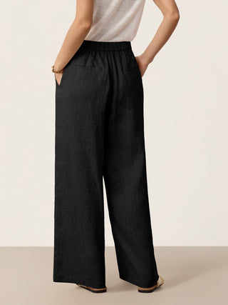 Charcoal black linen pants with buttoned slit hem from LINTICO's KATYA collection, stylish and lightweight for casual wear.