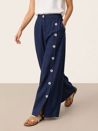 Navy blue linen pants with button details and slit hems from LINTICO's KATYA collection, designed as stylish bottoms for women.