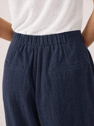 Navy blue linen buttoned slit-hem pants by LINTICO, featuring a relaxed fit and stylish design, perfect for casual or office wear.