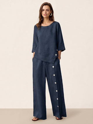 Navy blue linen pants with buttoned waistband and slit hem from LINTICO's KATYA collection, styled as stylish casual bottoms.