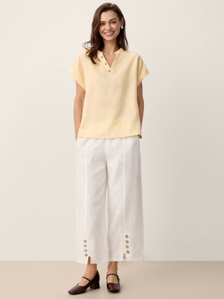 Optic white linen buttoned split-hem pants by LINTICO, featuring a relaxed fit and stylish design for casual wear.