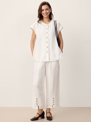 Optic white linen buttoned split-hem pants by LINTICO, showcasing relaxed fit and stylish design.
