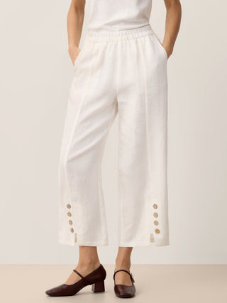 Optic white linen pants with buttoned waist and split hem from LINTICO's ALINA collection, casual and breathable bottom style.