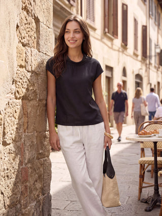 Charcoal black linen cap sleeve blouse with soft fold collar from LINTICO's Yvonne collection, showcasing a stylish, lightweight top.