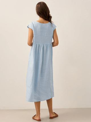 LINTICO linen maxi dress with cap sleeves in washed baby blue, featuring a relaxed fit and elegant midi length.