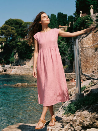 Pastel pink linen maxi dress with cap sleeves, washed finish, by LINTICO, styled as a lightweight, elegant midi dress.