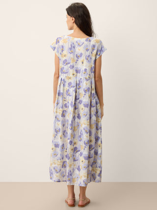 Linen maxi dress with carnation print, scalloped waist, by LINTICO, showcasing a flowy, floral design perfect for summer wear.