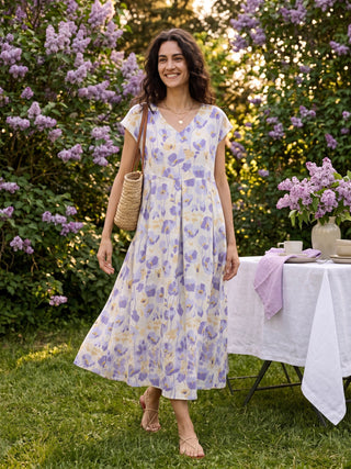 Linen maxi dress with carnation print, scalloped waist design, by LINTICO, featuring floral pattern and elegant midi length.