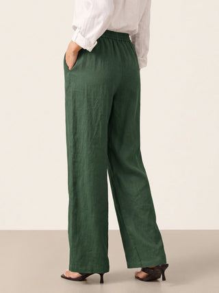 LINTICO 100% linen classic pants LYON in evergreen color, featuring a relaxed fit and tailored waistband, shown on a model.